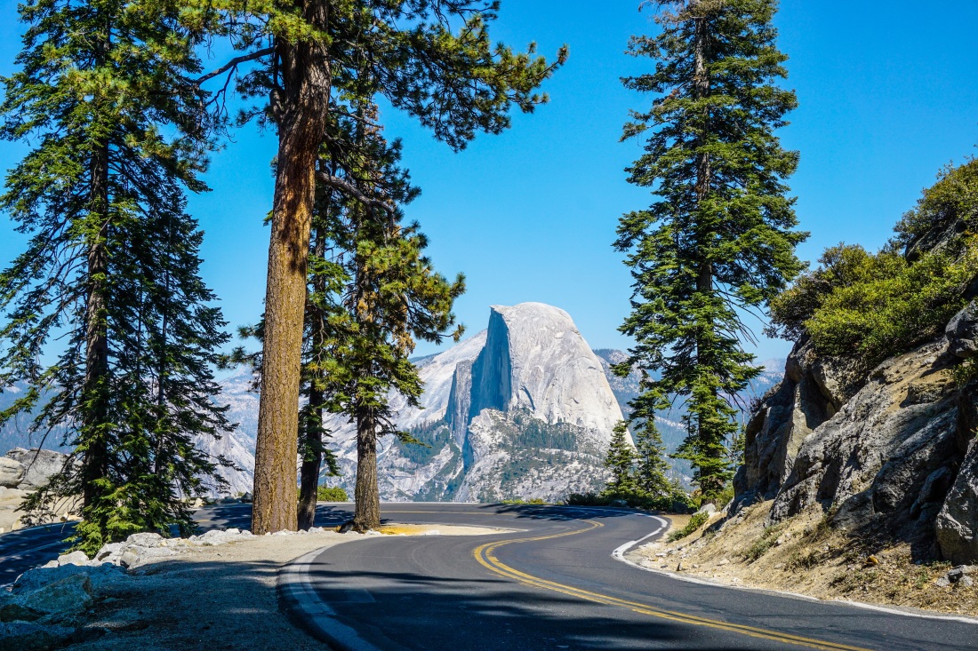 Blue skies and open road on the way to Glacier Point in Yosemite National Park, California.